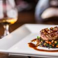 Beef Steak. Grill beef steak black lentils mixed with vegetable. Cognac or brandy as drink. Culinary food in hotel pub or restaurant